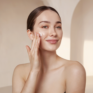 woman putting on skincare lotion